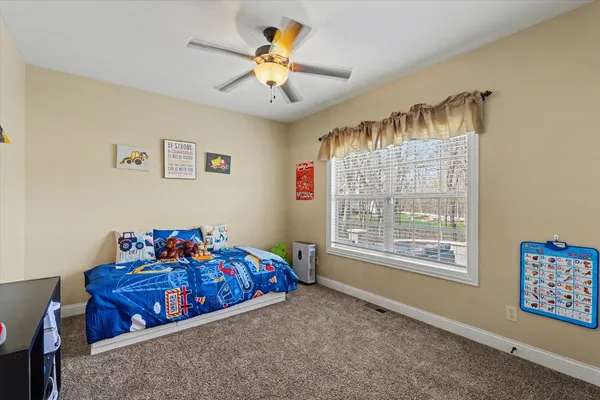 a bedroom with furniture and a window