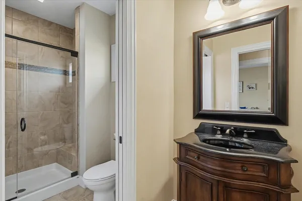 a bathroom with a sink a toilet and shower