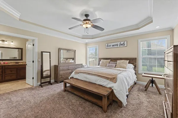 a spacious bedroom with a bed and a cabinet