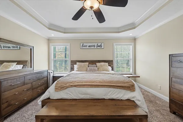 a bedroom with a large bed and a chandelier