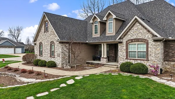 a front view of a house with a yard and porch