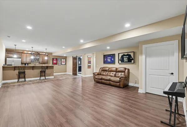 a living room with furniture and a wooden floor