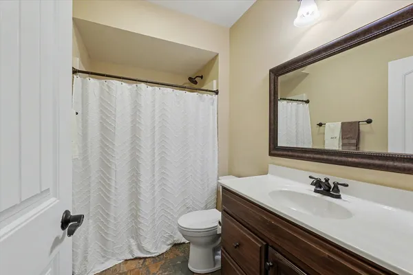 a kitchen with stainless steel appliances granite countertop a sink a stove and a wooden floor