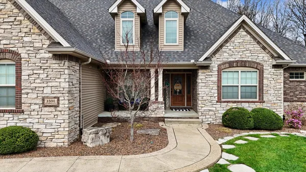 a front view of a house with garden