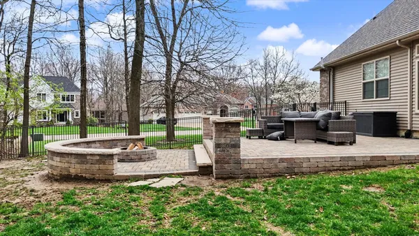 a view of a patio with a chairs and a fire pit