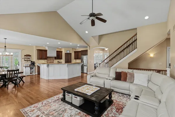 a living room with furniture and wooden floor