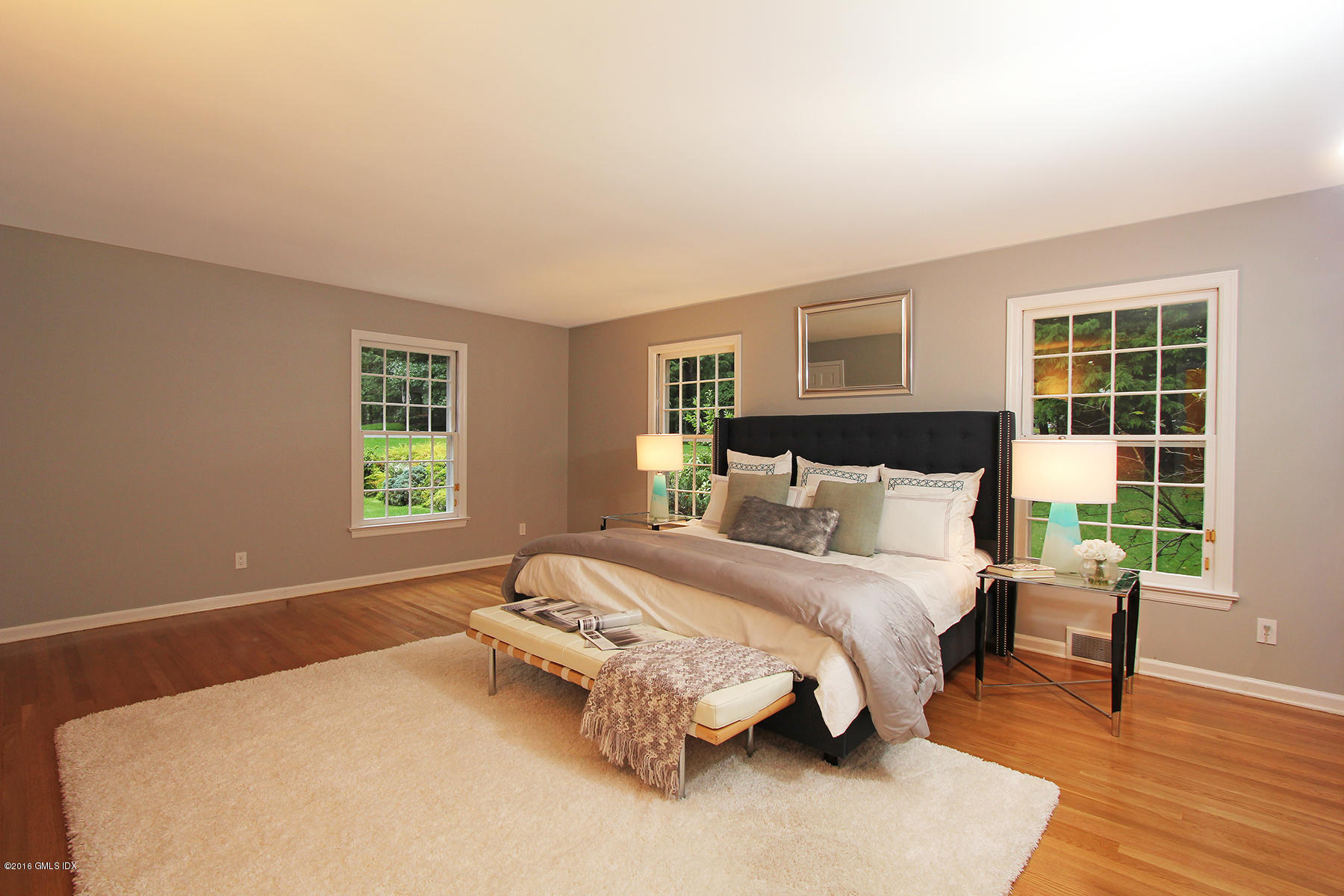 55 Sawmill Lane Greenwich, CT 06830 - Photo 12 of 26 a bed room with a bed and a chair