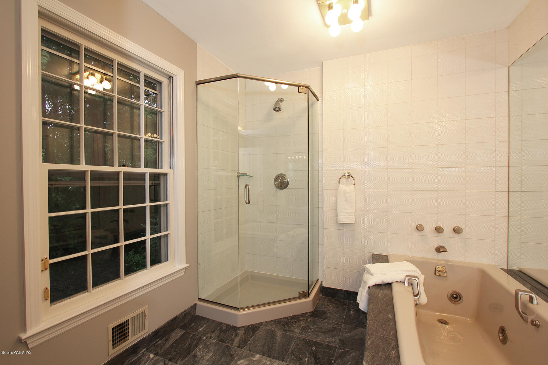 55 Sawmill Lane Greenwich, CT 06830 - Photo 15 of 26 a bathroom with a tub and a shower