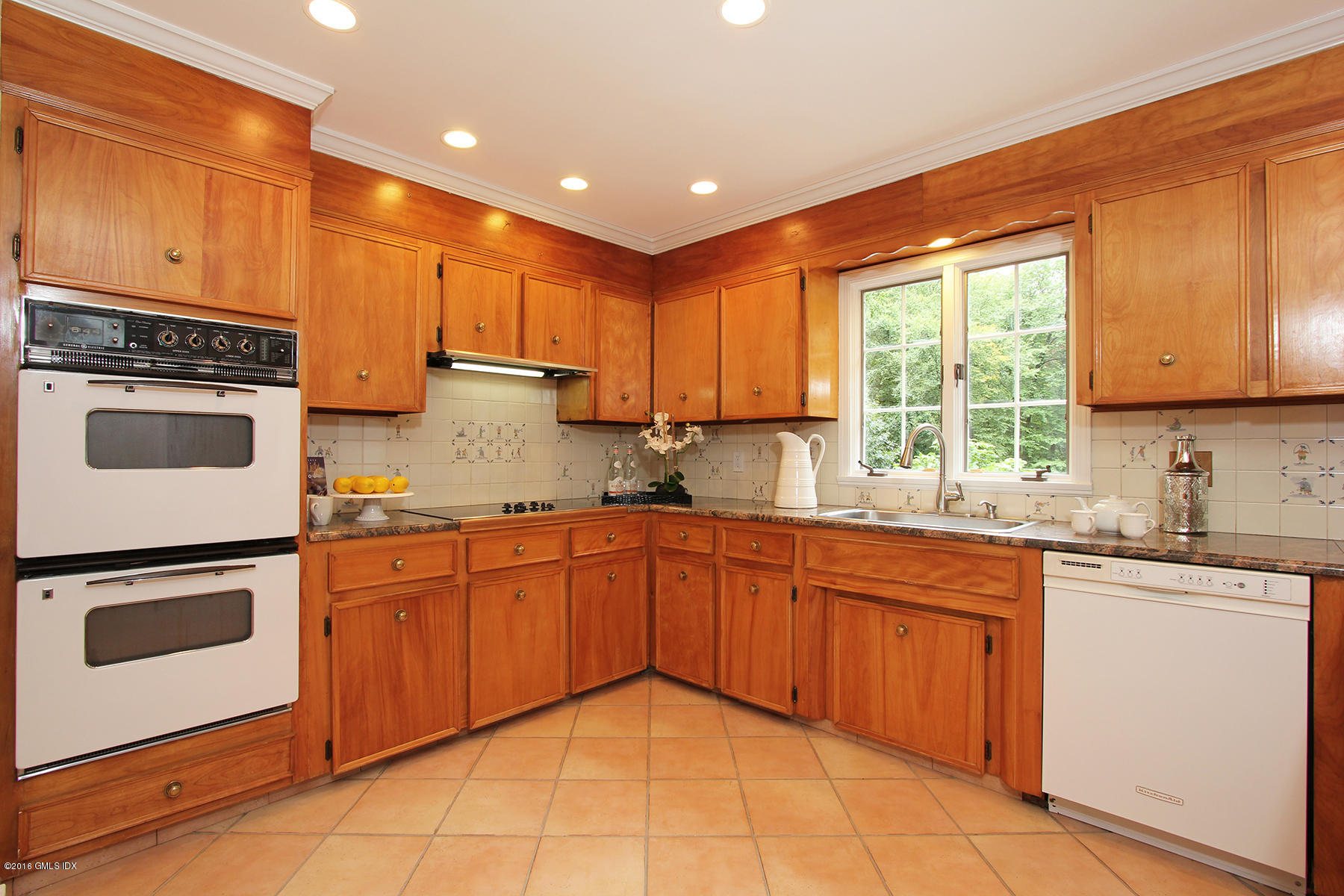 55 Sawmill Lane Greenwich, CT 06830 - Photo 10 of 26 a kitchen with granite countertop stainless steel appliances and sink