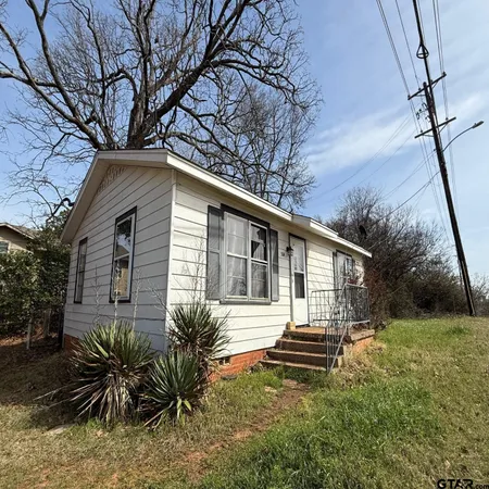 a house that has a tree in front of the house