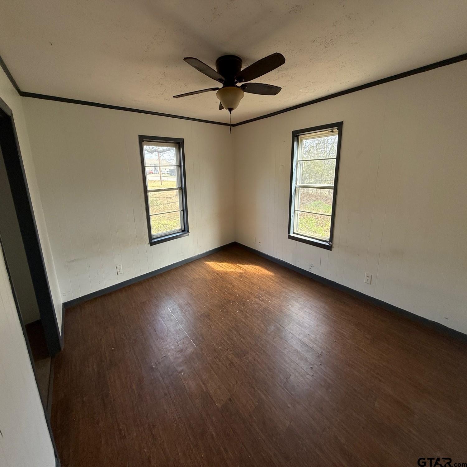 504 West Main Street Whitehouse, TX 75791 - Photo 7 of 10 wooden floor in an empty room with a window
