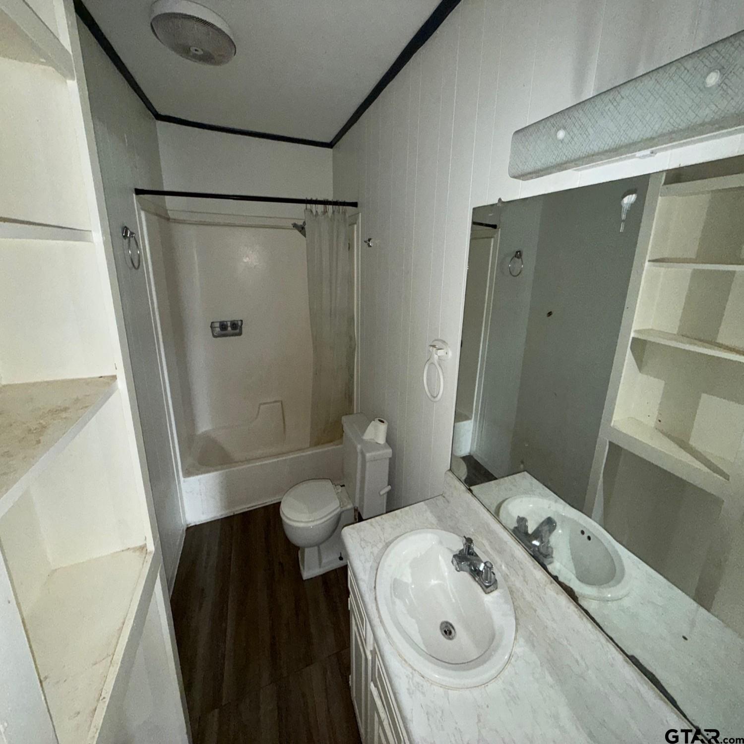 504 West Main Street Whitehouse, TX 75791 - Photo 8 of 10 a bathroom with a sink and a mirror