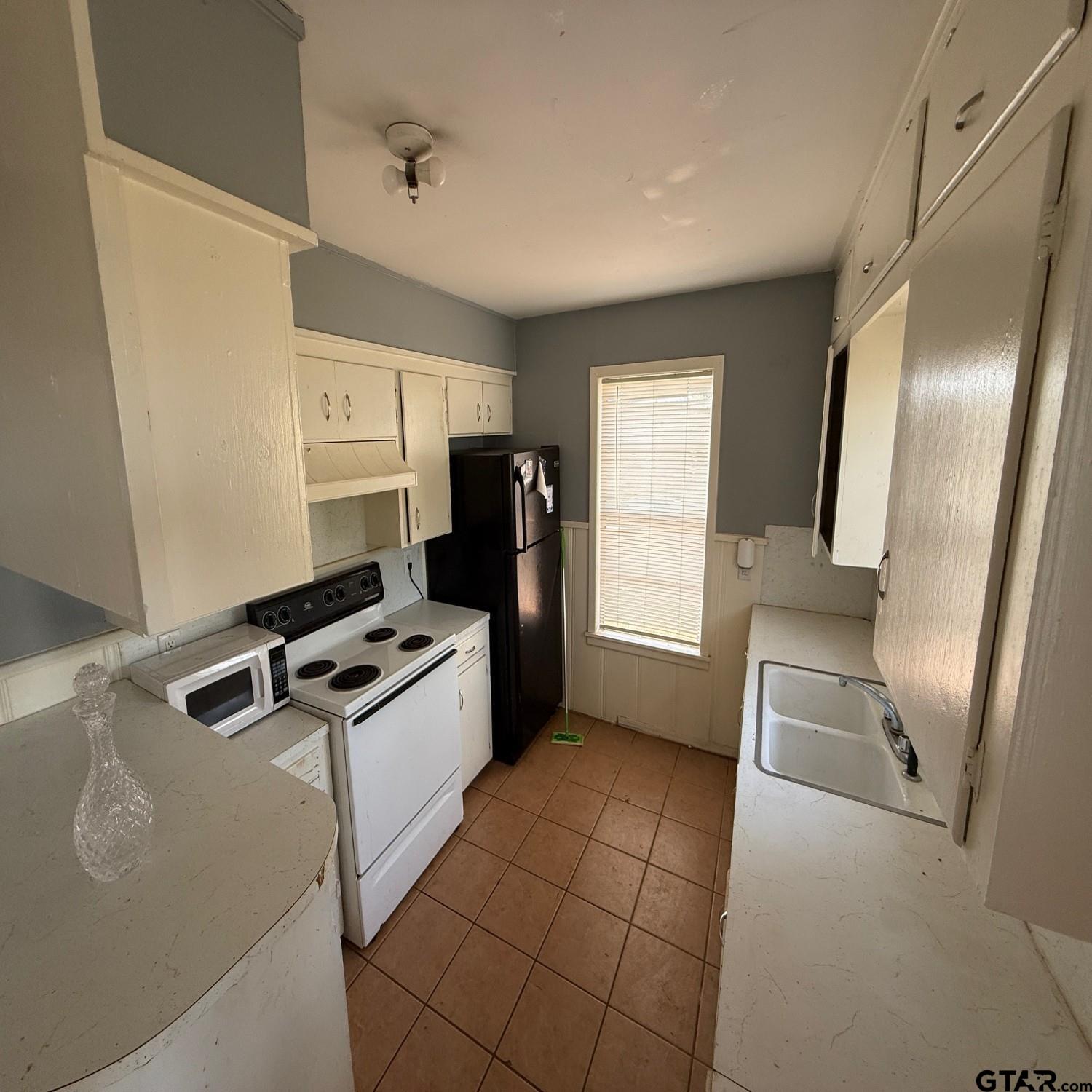 504 West Main Street Whitehouse, TX 75791 - Photo 9 of 10 a kitchen with granite countertop a stove and a refrigerator