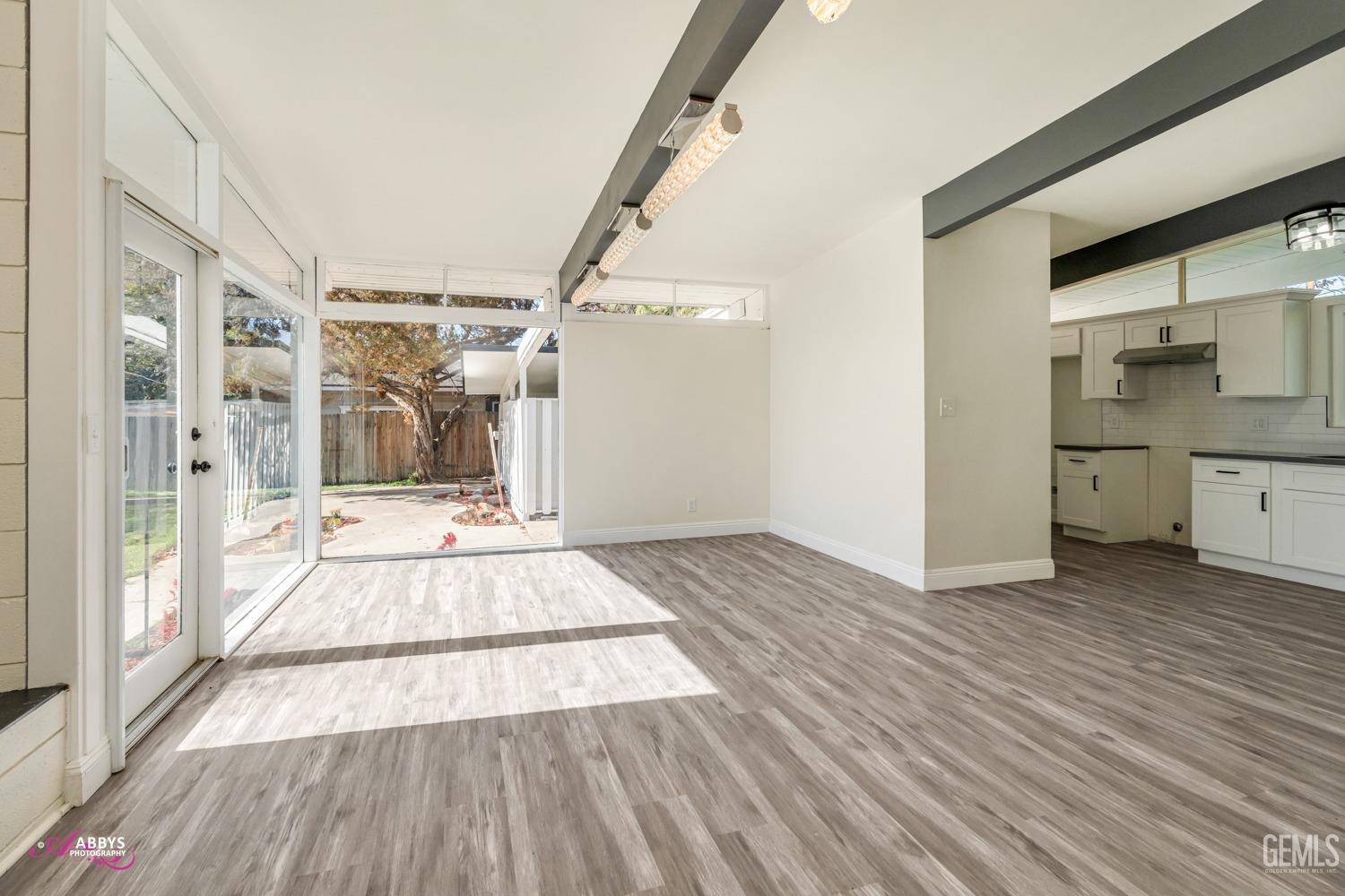 Undisclosed Address Bakersfield, CA 93306 - Photo 24 of 32 a view of an empty room with window and wooden floor