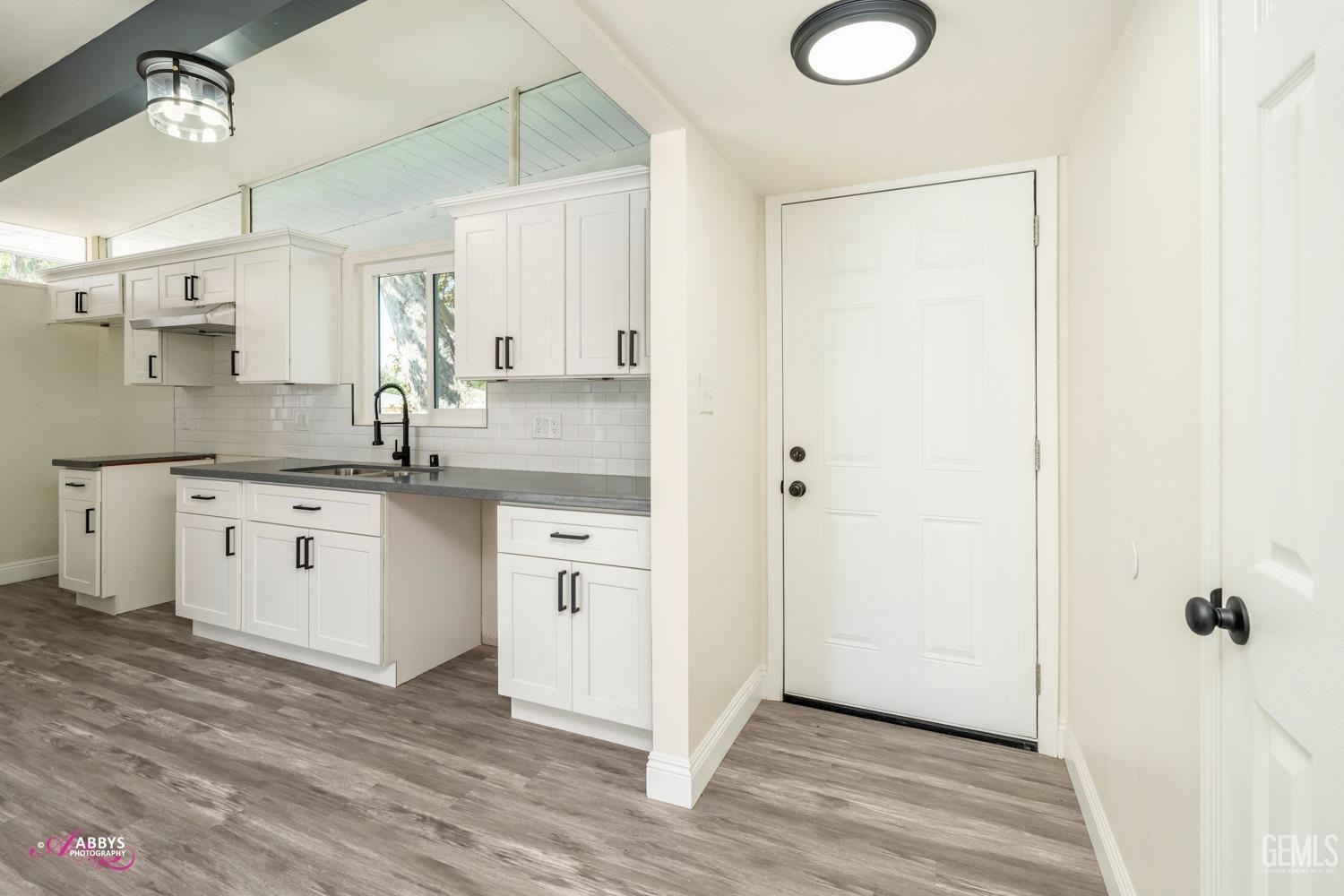 Undisclosed Address Bakersfield, CA 93306 - Photo 27 of 32 a kitchen with a sink cabinets and wooden floor