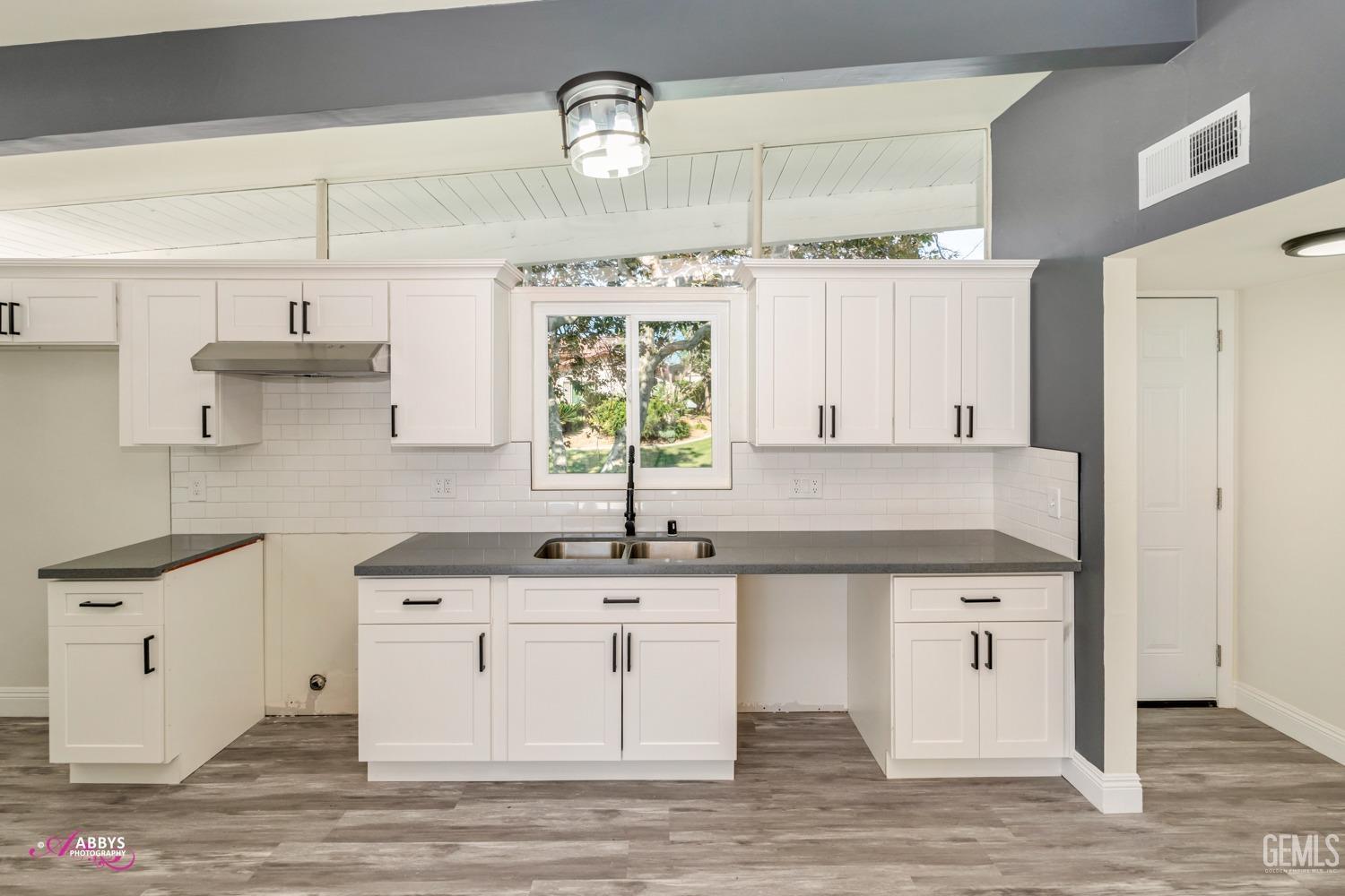 Undisclosed Address Bakersfield, CA 93306 - Photo 28 of 32 a kitchen with a sink cabinets and wooden floor
