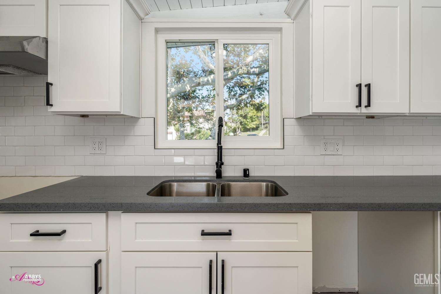 Undisclosed Address Bakersfield, CA 93306 - Photo 30 of 32 a kitchen with granite countertop a sink and a window