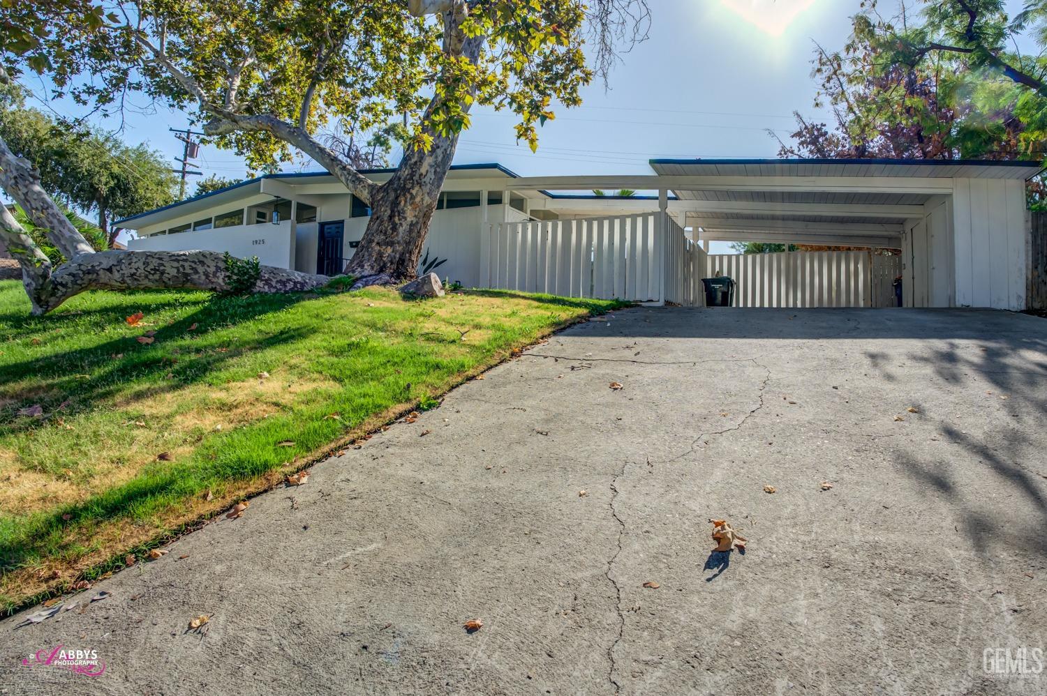 Undisclosed Address Bakersfield, CA 93306 - Photo 3 of 32 a front view of a house with a garden and deck
