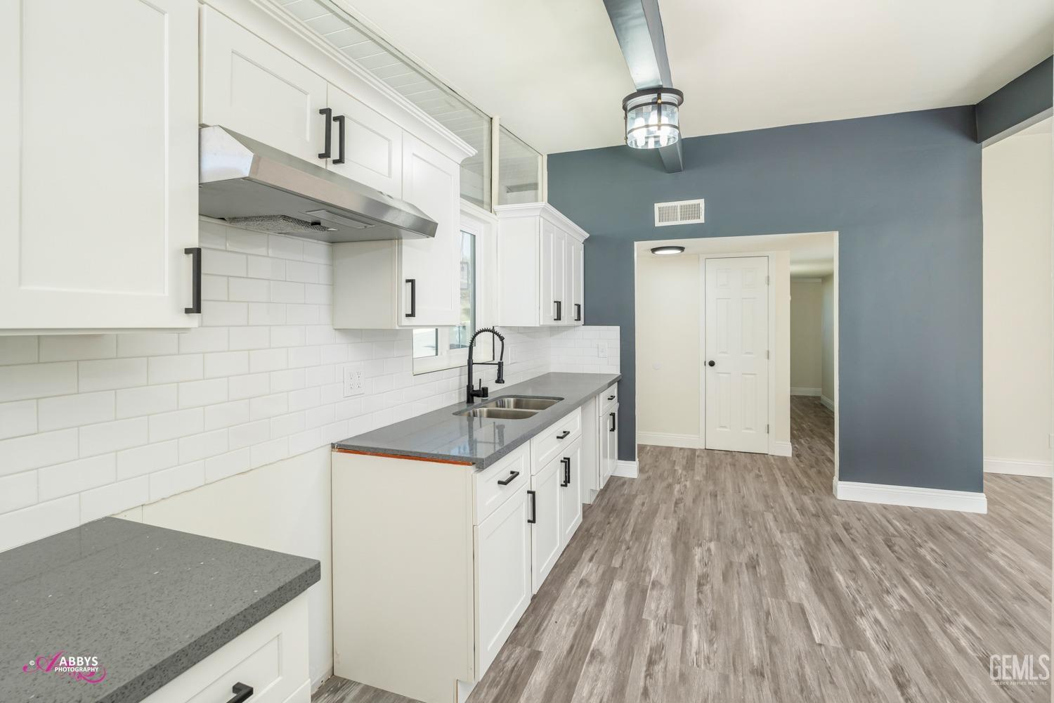 Undisclosed Address Bakersfield, CA 93306 - Photo 31 of 32 a kitchen with granite countertop a sink and a stove