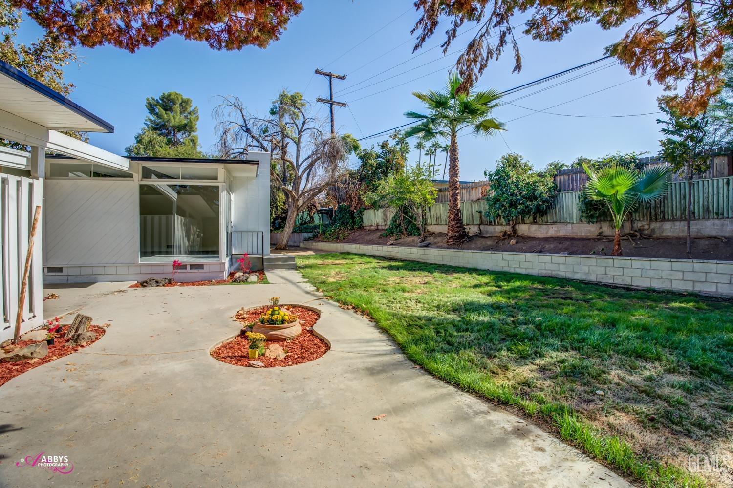 Undisclosed Address Bakersfield, CA 93306 - Photo 5 of 32 a front view of a house with garden