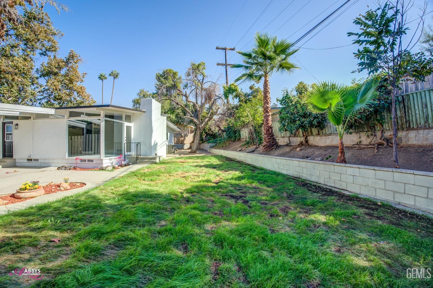 Undisclosed Address Bakersfield, CA 93306 - Photo 6 of 32 a front view of a house with garden