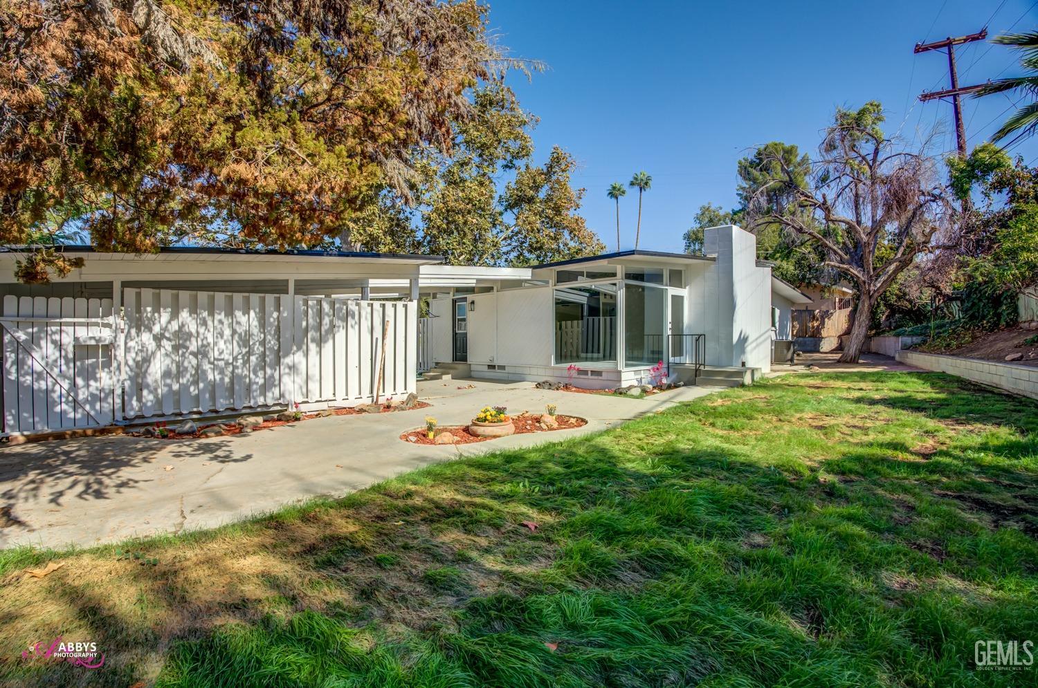 Undisclosed Address Bakersfield, CA 93306 - Photo 7 of 32 a front view of a house with garden