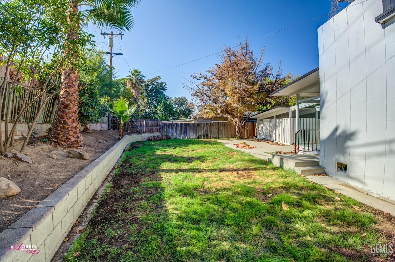 Undisclosed Address Bakersfield, CA 93306 - Photo 8 of 32 a backyard of a house with lots of green space