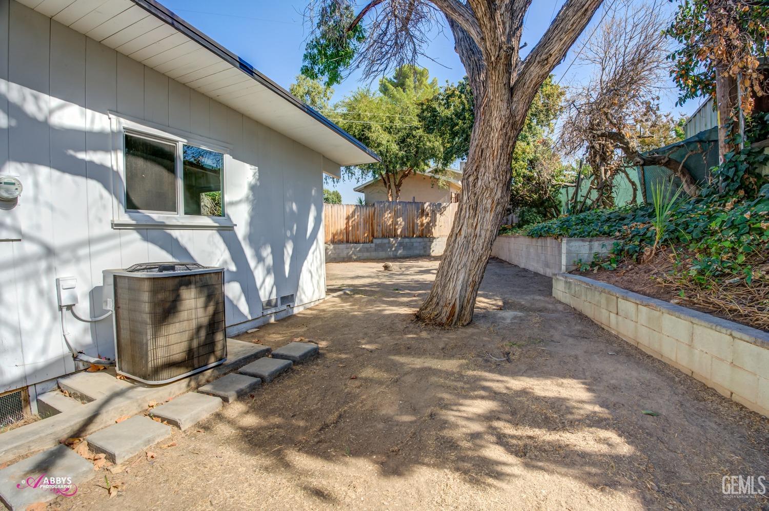 Undisclosed Address Bakersfield, CA 93306 - Photo 10 of 32 a view of a house with backyard