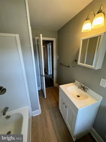a bathroom with a sink a mirror and a toilet