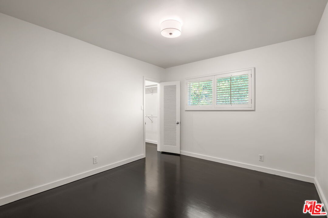 3621 Longview Valley Road Sherman Oaks, CA 91423 - Photo 13 of 25 an empty room with wooden floor and windows