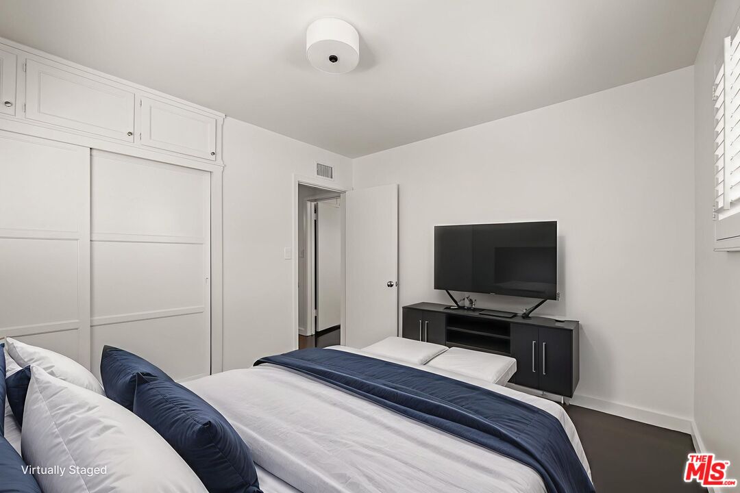 3621 Longview Valley Road Sherman Oaks, CA 91423 - Photo 18 of 25 a bedroom with a bed and a flat screen tv