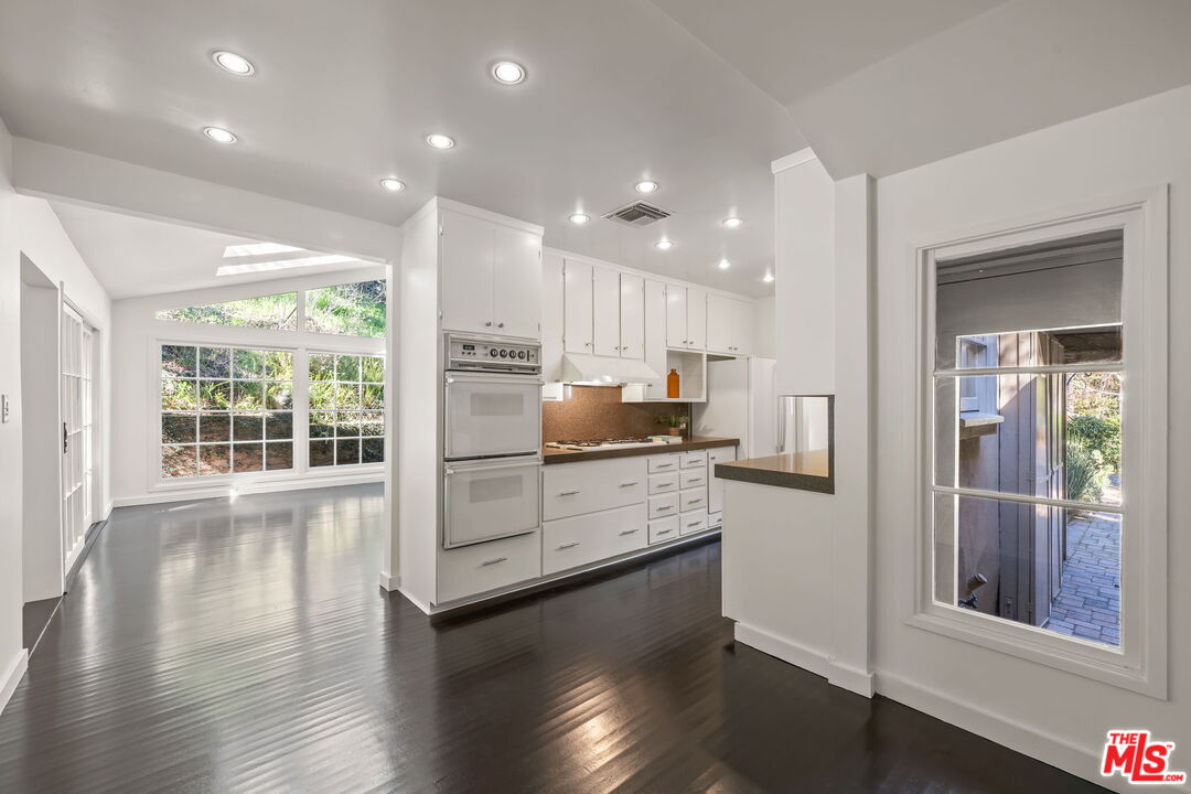 3621 Longview Valley Road Sherman Oaks, CA 91423 - Photo 5 of 25 a kitchen with stainless steel appliances granite countertop a refrigerator sink and cabinets