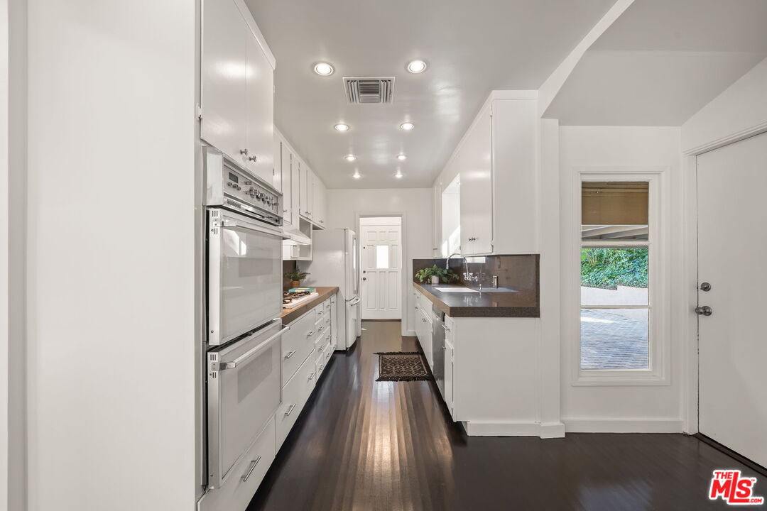 3621 Longview Valley Road Sherman Oaks, CA 91423 - Photo 6 of 25 a view of a kitchen with a sink and refrigerator