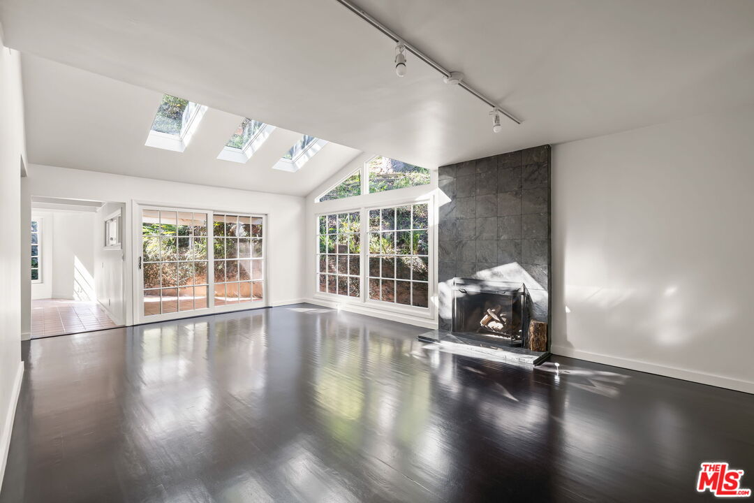 3621 Longview Valley Road Sherman Oaks, CA 91423 - Photo 9 of 25 a view of empty room with wooden floor and fan