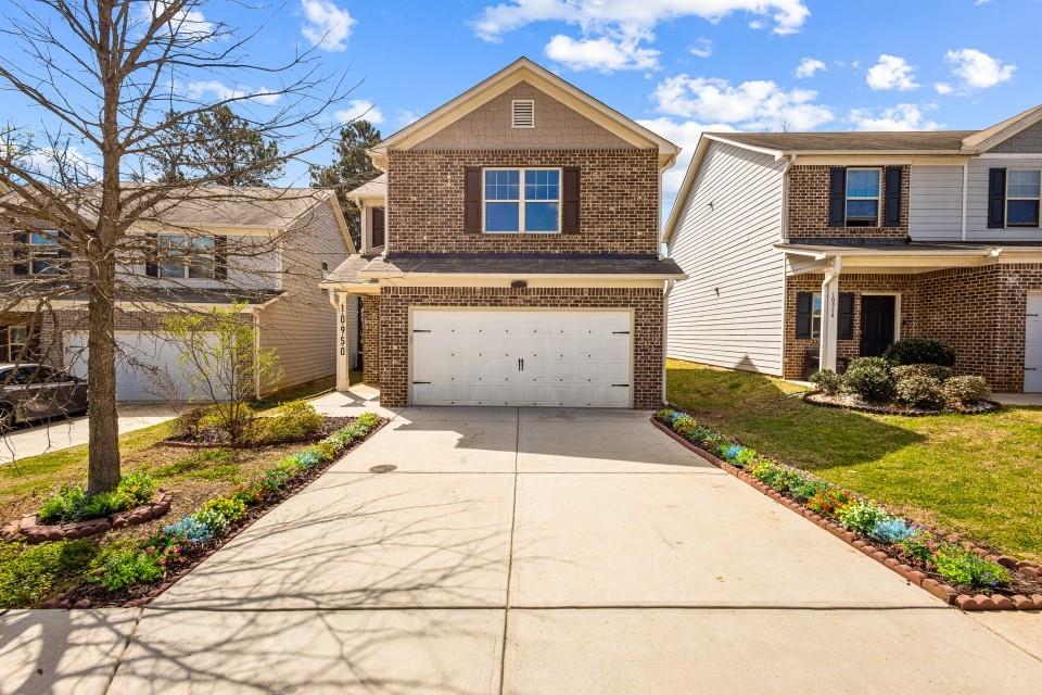 a front view of a house with a yard