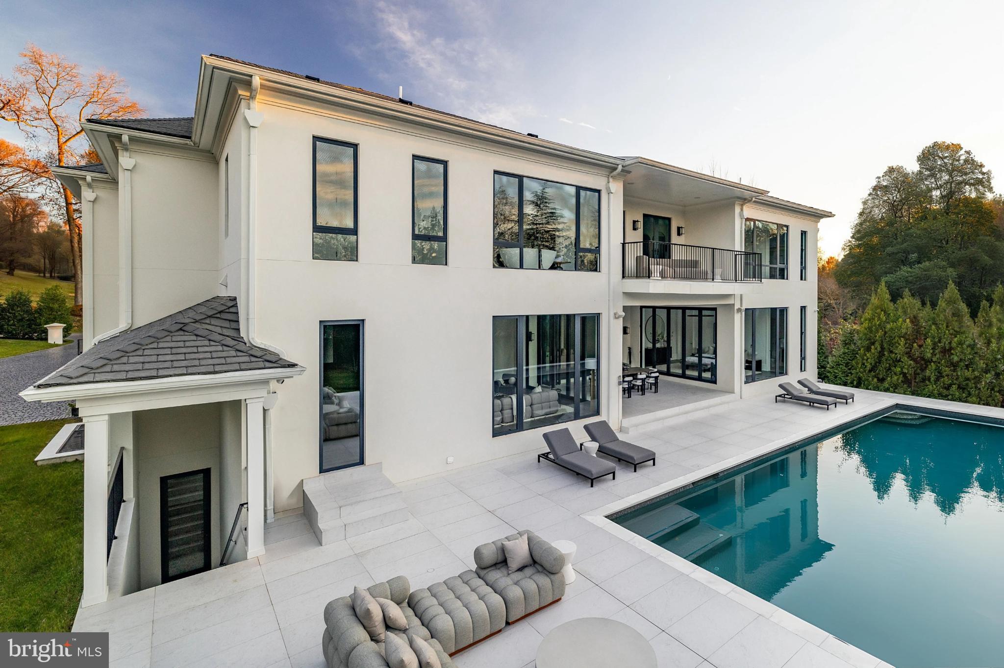 1102 Chain Bridge Road McLean, VA 22101 - Photo 15 of 50 a view of a house with swimming pool and sitting area
