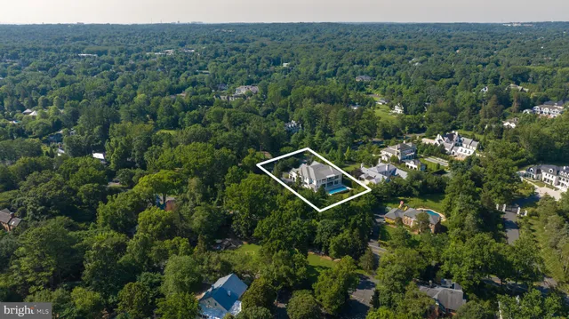 an aerial view of a house with a yard and street view