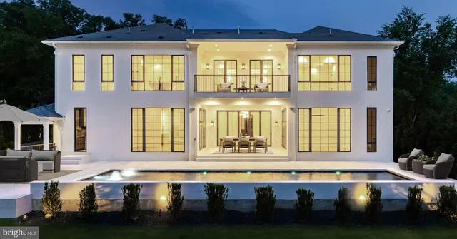 a front view of a residential apartment building with a swimming pool and outdoor seating