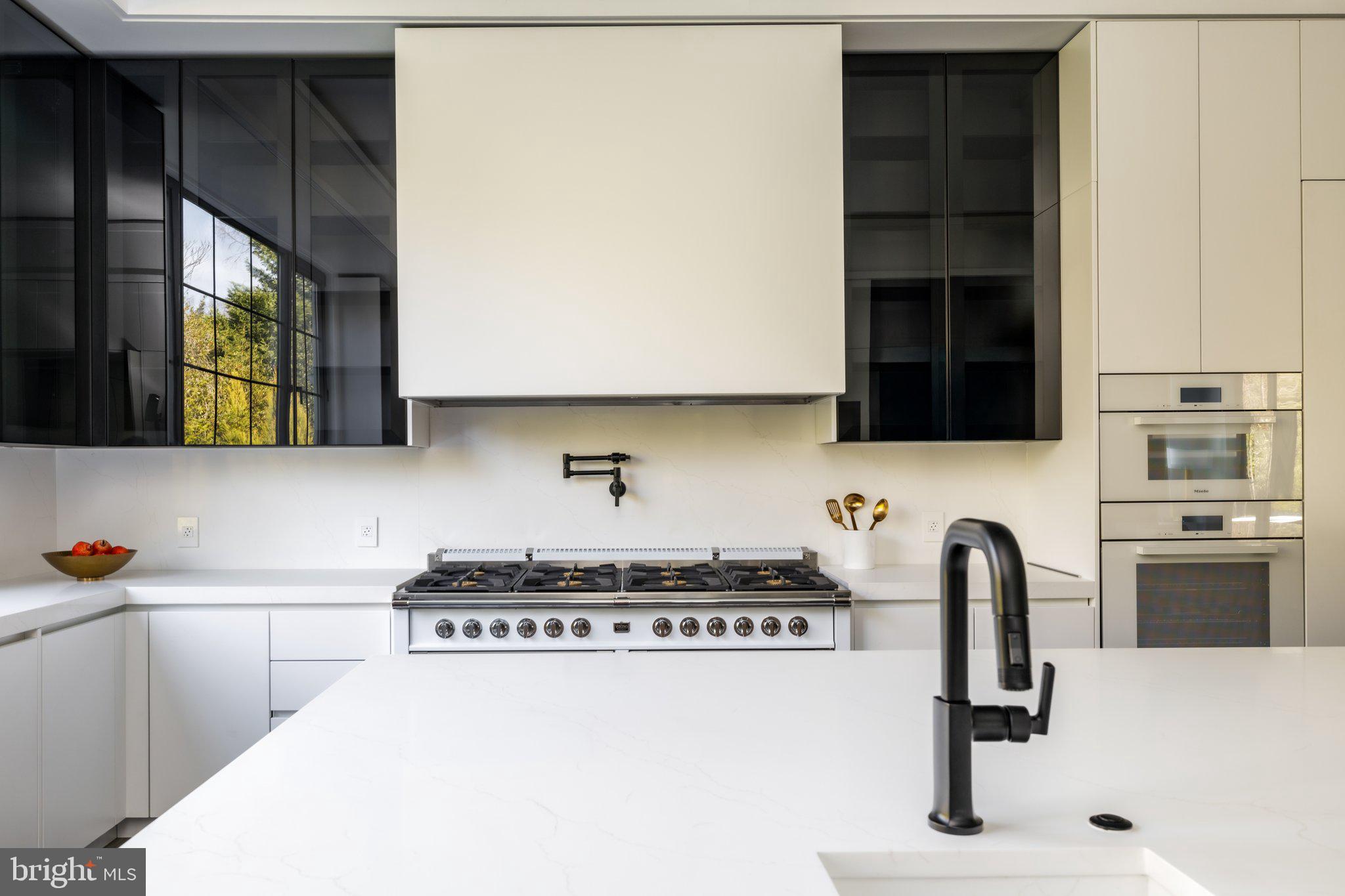 1102 Chain Bridge Road McLean, VA 22101 - Photo 18 of 50 a kitchen with a sink and a stove
