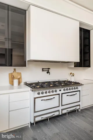a kitchen with granite countertop a stove and a sink
