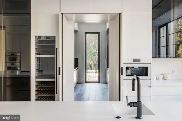 a kitchen with kitchen island stainless steel appliances a sink stove and refrigerator