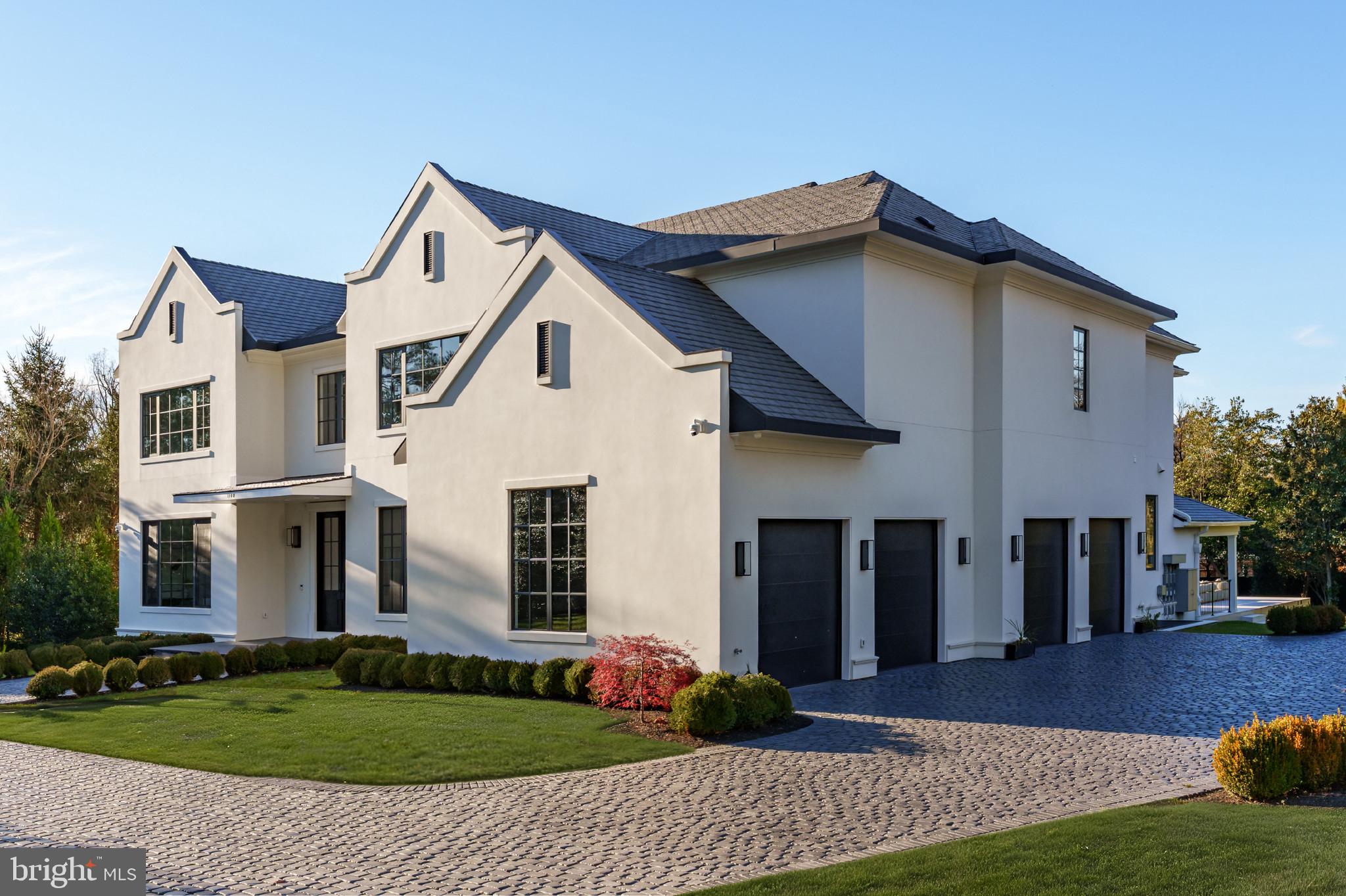 1102 Chain Bridge Road McLean, VA 22101 - Photo 2 of 50 a front view of a house with a yard