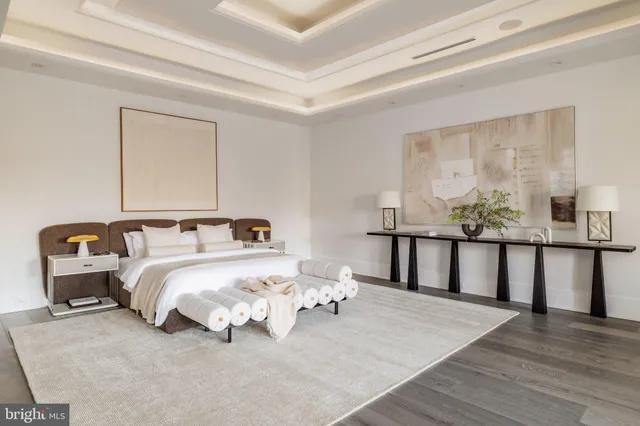 a bedroom with a large bed and a large window