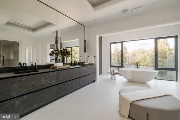 a hallway with wooden floor a glass door and furniture