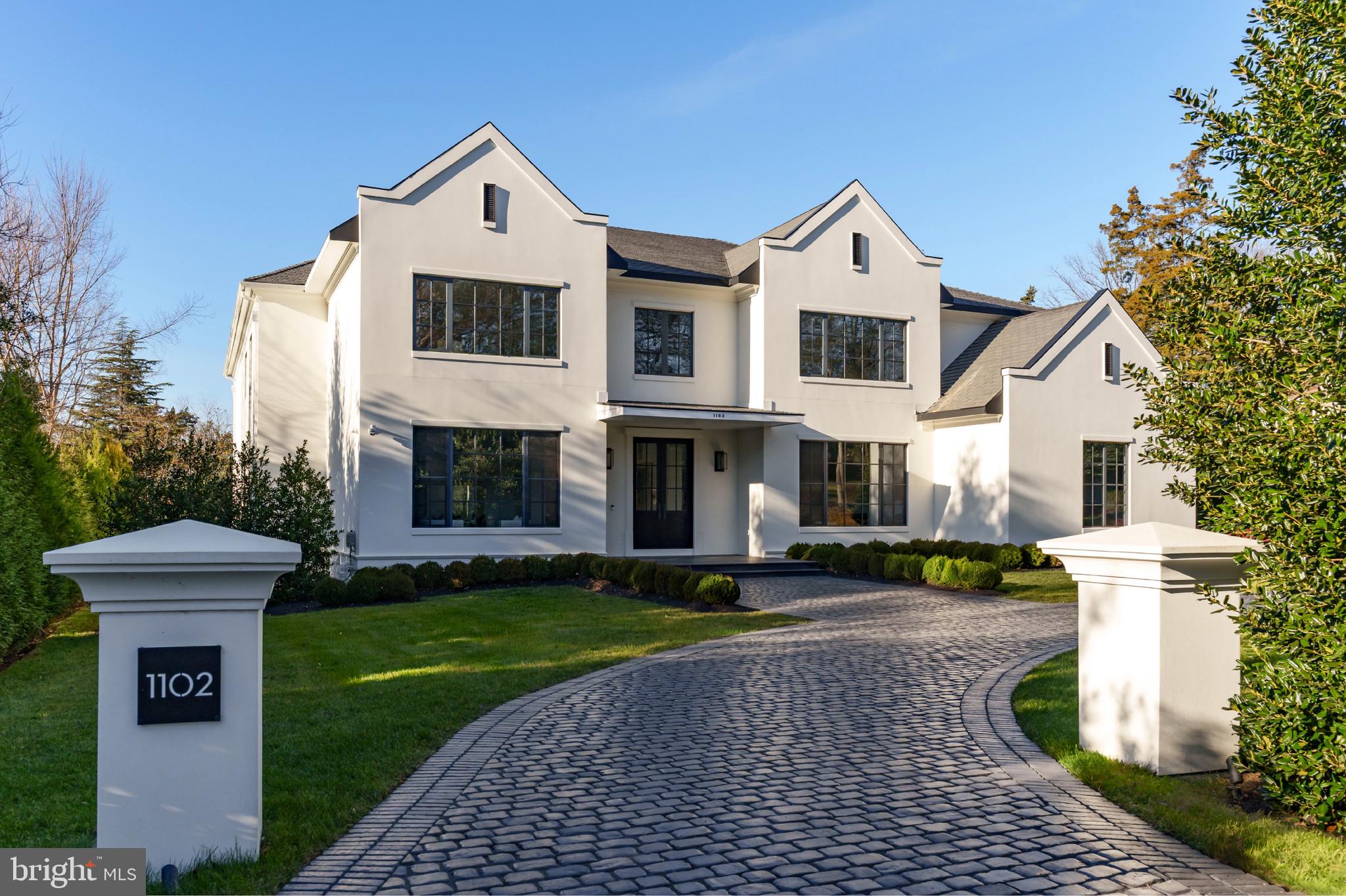1102 Chain Bridge Road McLean, VA 22101 - Photo 4 of 50 a front view of a house with a yard and trees