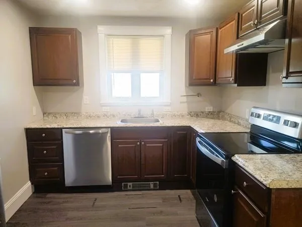 a kitchen with stainless steel appliances granite countertop a sink stove and microwave
