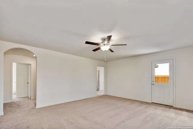 a view of a livingroom with a ceiling fan and window