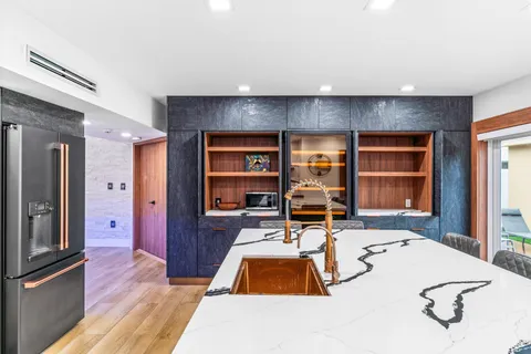 a living room with furniture a flat screen tv and a table