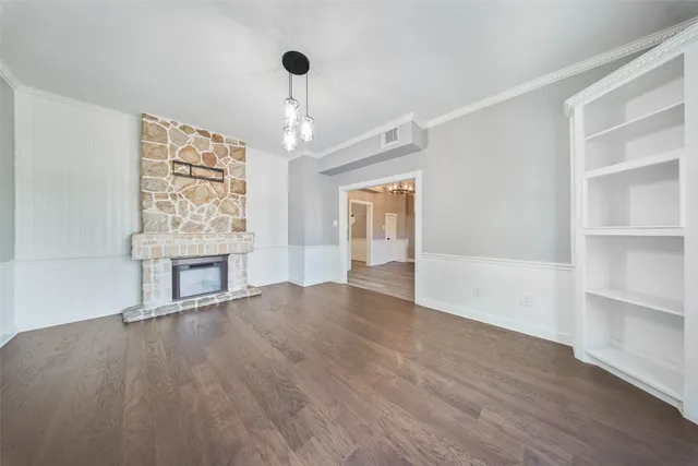 a view of a kitchen with a sink and an empty room