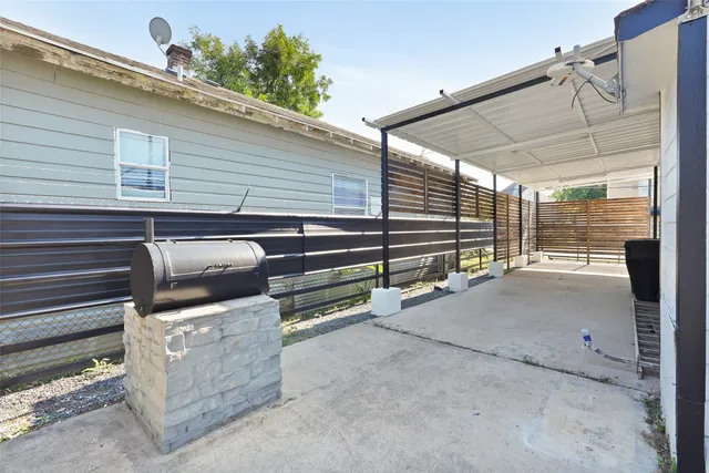 a kitchen with granite countertop a refrigerator oven a sink dishwasher and white cabinets with wooden floor